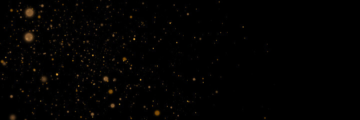 Glowing light effect in yellow gold color with lots of shiny particles isolated on dark background. Vector star cloud with dust.	
