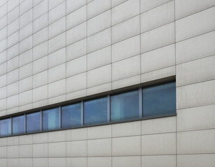 A modern building, windows, a fragment of modern urban development, a ceramic wall ...