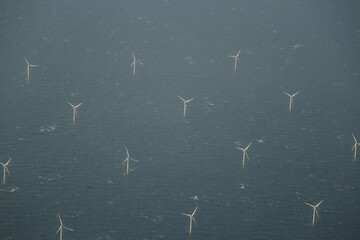 Off shore wind farm supplying renewable energy from wind turbines in the North Sea between England and Holland taken from the air