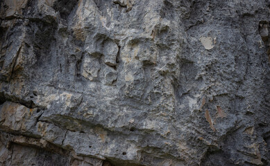 Natural dark background. Structure in dolomite rock. Dark abstract texture.