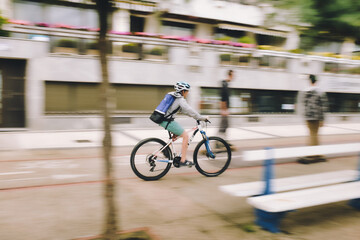 San Sebastian, Spain, 5th august 2017. 
Young cyclist riding a bike through the streets of San Sebastian. Shoot using panning technique to get a sense of movement.