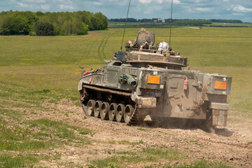 British army Warrior FV510 light infantry fighting vehicle tank in action on a military exercise,...