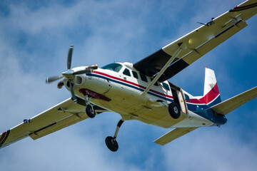 Cessna 208b Grand Caravan G-BZAH light aircraft returning to land under a bright blue sky, Wilts UK