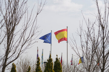 European and Spanish flag in park with trees, Madrid, Spain