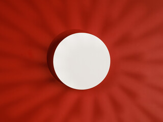 Top view of round white podium or pedestal on red background with round shadows.