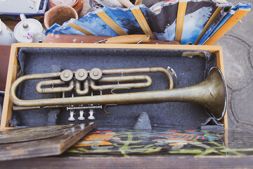 Old musical trumpet in a wooden box close up,music