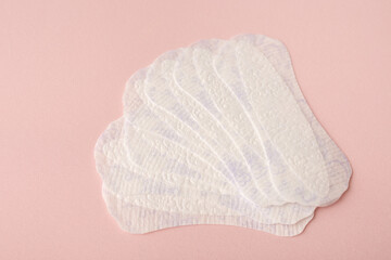 White sanitary pads, hygiene protection on a pink background. Gynecological menstrual cycle