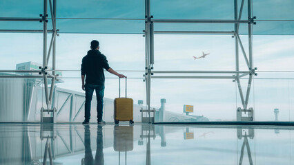 Passenger with baggage at international airport walking to terminal gate - Travel and transportation concept