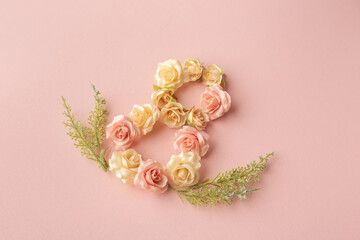 March 8th. Happy Women's Day. Creative layout. Composition in the form of the number eight of rosebuds on a pink background