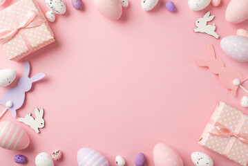 Fototapeta na wymiar Top view photo of easter decorations gift boxes easter bunnies pink lilac and white easter eggs on isolated pastel pink background with copyspace in the middle