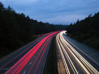 Long exposure of traffic lights on the M54 motorway among forests in Staffordshire, England, UK
