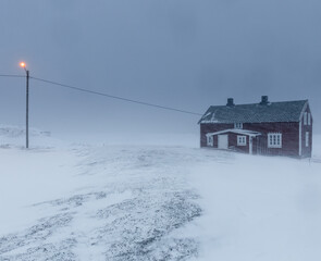  small wooden hut in the snow storm