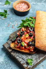 Italian ciabatta with chopped tomato vegetables, herbs and oil on grilled or toasted crusty baguette. Delicious breakfast or snack, Clean eating, dieting, vegan food concept. top view