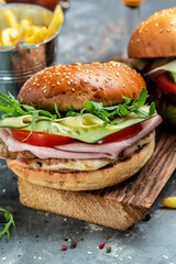 burger with ham, cheese, bacon, salad and vegetables. Big burger, american fast food. banner, menu, recipe place for text