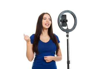 The beautiful girl blogger communicates with the subscribers of her channel using a smartphone and...