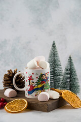 Coffee on wood plate with marshmellow and sliced dry orange