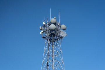 communication tower with parabolic microwave antennas with molded gray radome