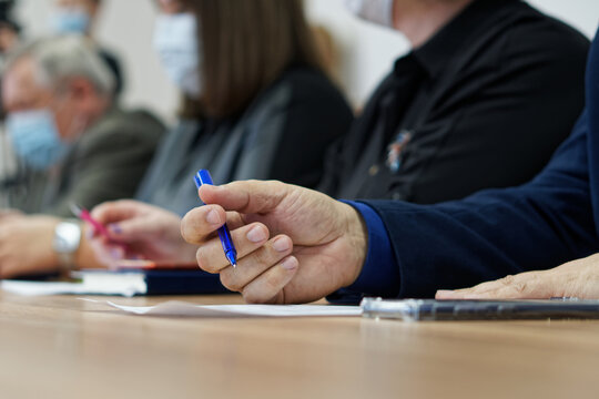 Businessman's hands and pen on the table next to the document. Age official, boss, lawyer or businessman. Retraining. Participation in the meeting and signing of documents. No face