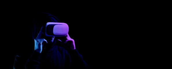 Virtual reality game vr. Young man in digital glasses for virtual reality technology isolated on dark neon background. Study and virtual world in 3D simulation.