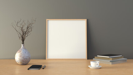 Square BBB picture poster frame mock up. Cup of coffee, books, vase and notebook on wooden table. Gray wall background.