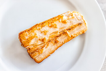 Grilled baked or fried mahi mahi seafood fish closeup above flat top view with white plate and...