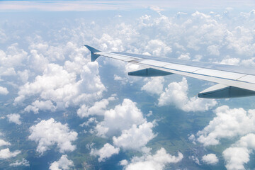 Window high angle aerial view of airplane landing in southwest Florida cloudscape natural clouds...
