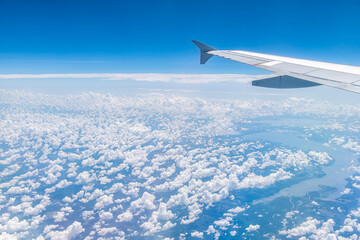 Window high angle aerial view of blue sky horizon above Virginia on sunny day cloudscape natural clouds pattern formation and Potomac River flowing into Chesapeake Bay