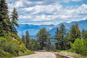 Fototapeta premium Carson National Forest highway 76 with Sangre de Cristo mountains in background with green pine tree forest in summer at high road to Taos