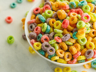 Close-up. Large bowl with multi-colored fruit rings on a white background. The concept is whole grain breakfasts, organic food, baby food, diet, sports, fitness. Banner.