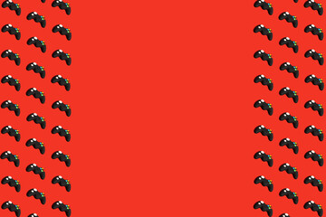 Colorful seamless pattern with gamepads on red background. Creative concept of video game or gaming...