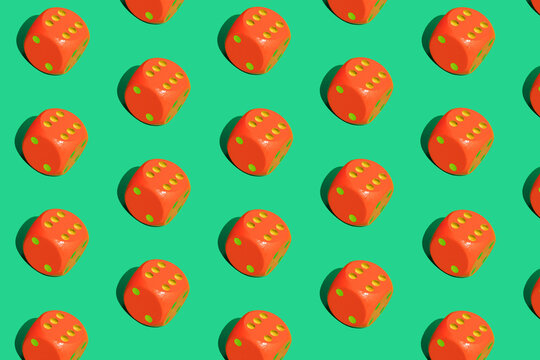 Seamless pattern of red dices on green background.