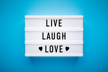 Lightbox on blue background: live, laugh, love