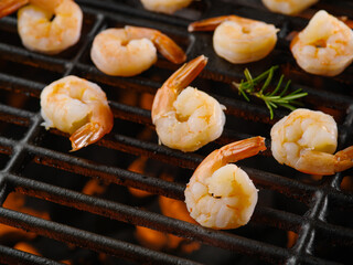Sea food. shrimps with sprigs of rosemary are fried on the grill. Seafood cooking. Eastern and Asian cuisine. Restaurant, hotel, picnic, banquet.