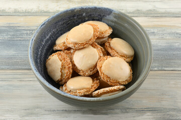 Vanilla and apricot macaron cookies also called holy belly buttons in ceramic snack bowl