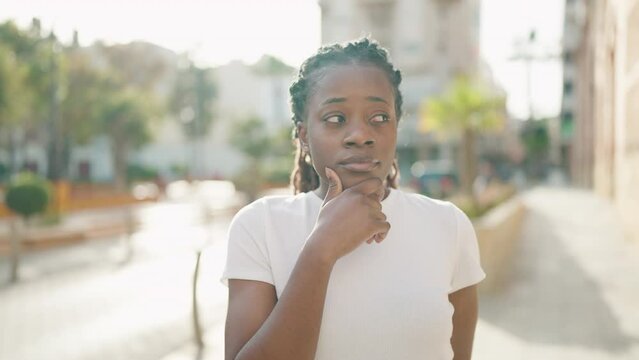 African american woman standing with doubt expression at street