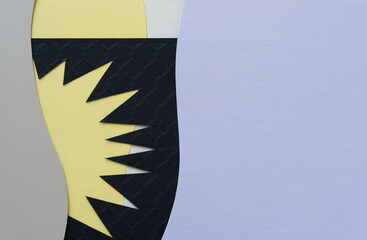 background with irregular paper shape in black on yellow and mauve