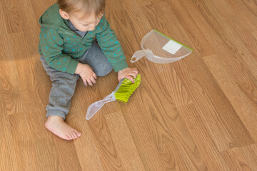 20 month old toddler playing with dustpan and brush; mimicry developmental milestone