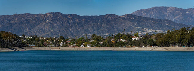 Panoramic view of Silver Lake in downtown Los Angeles with birds flying across the lake in spring