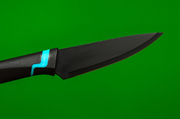 black kitchen knife on a green background