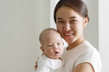 Portrait smiling Asian mother with her newborn baby