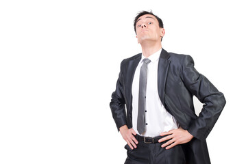 Confident businessman keeping hands on waist and looking arrogant