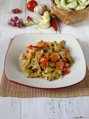 Plateful of oseng bunga turi or stir fried edible flower of Sesbania grandiflora is Indonesian daily home dish. Mixed with carrot or other vegetable. Simple and easy.