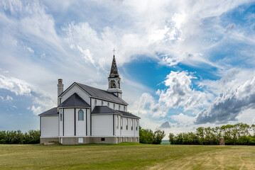 Fototapeta na wymiar A dramatic sky over the back of the Blumenfeld Roman Catholic Church near Leader, SK, Canada