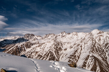 Snowy Greater Caucasus ridge. Sunny day. Before suset. View from 3500m