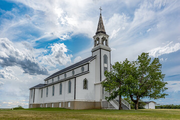 Fototapeta premium A dramatic sky over the Blumenfeld Roman Catholic Church near Leader, SK, Canada