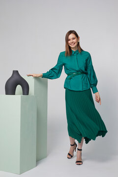 Fashion woman in trendy turquoise blouse and green skirt.
