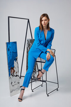 Fashion woman in blue trendy suit.