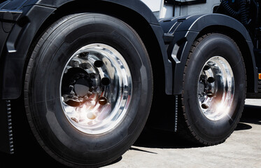 Fototapeta na wymiar Big Rig Semi Truck Wheels Tires. Lorry New Tyres Rubber. Freight Trucks Transport. 