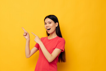 Obraz premium woman with Asian appearance red t-shirts posing modern style isolated background unaltered