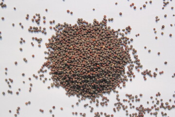 Mustard seeds on white background